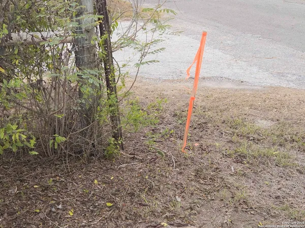 a view of wooden house with a yard