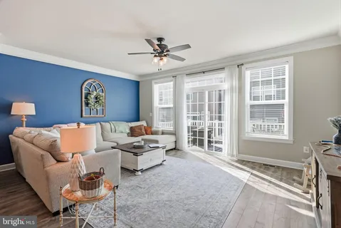 a living room with furniture a table and a large window