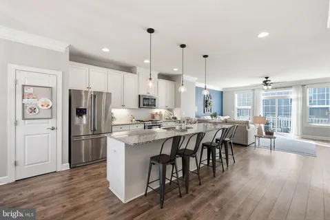 a large kitchen with a table and chairs