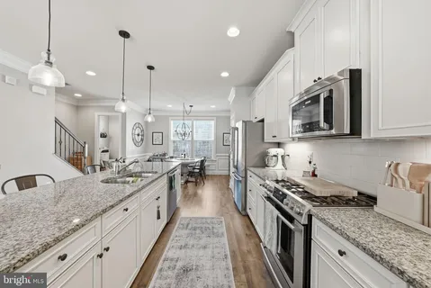 a kitchen with sink stove and cabinets