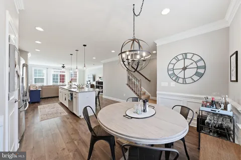 a view of a dining room with furniture wooden floor and chandelier
