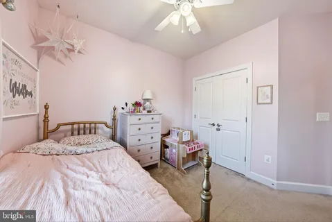 a bedroom with a bed and chandelier