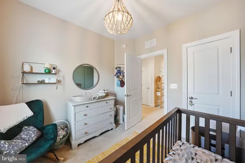a view of a bedroom with furniture and wooden floor