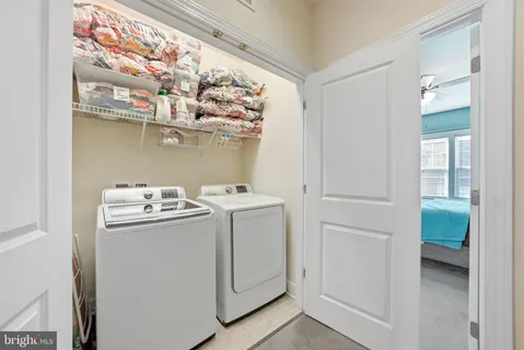 a view of storage and utility room with washer and dryer