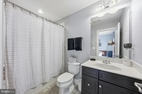 a bathroom with a sink a toilet and mirror