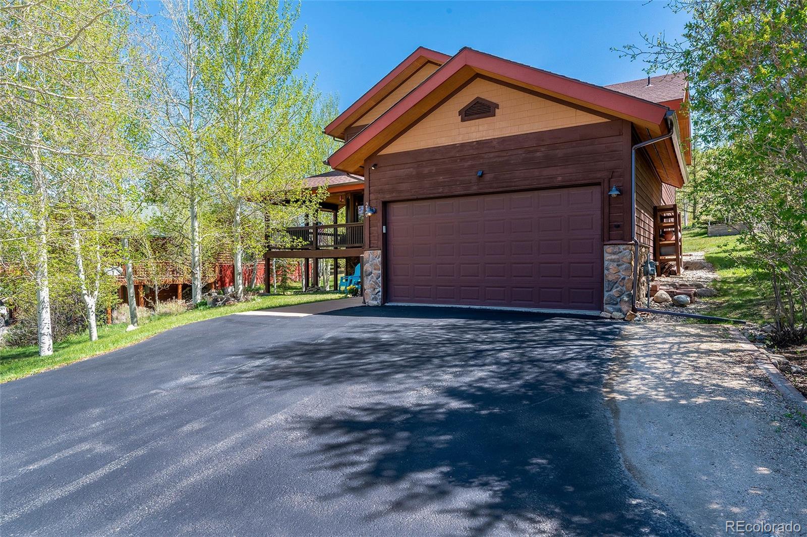 290 Village Road Granby, CO 80446 - Photo 2 of 45 a front view of a house with a yard and garage