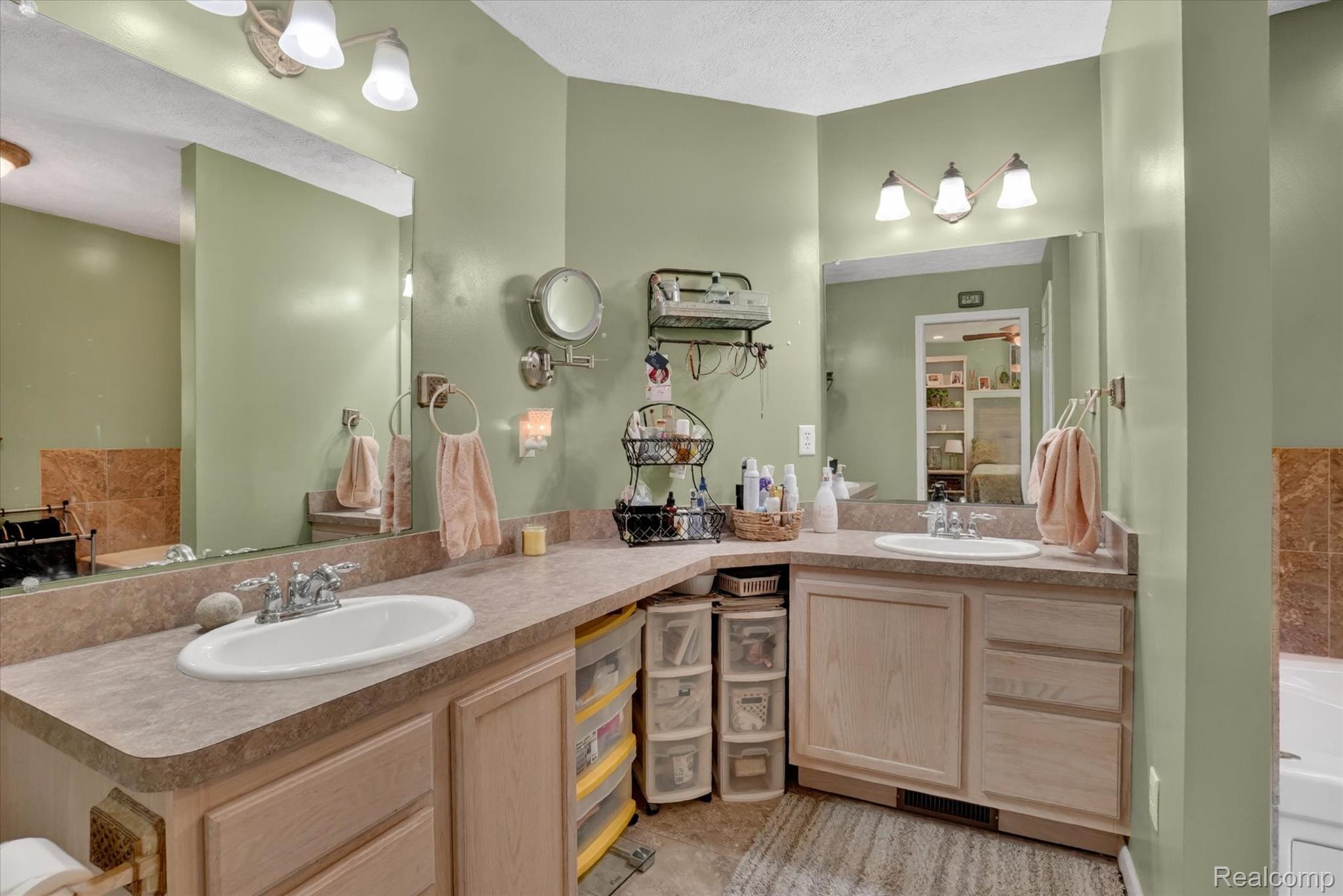 9565 Crofoot Road Fowlerville, MI 48836 - Photo 24 of 63 Dual basin vanity with laminate countertops and light wood cabinetry