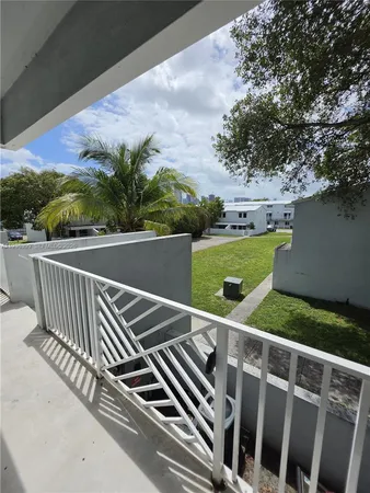 a view of a balcony and yard