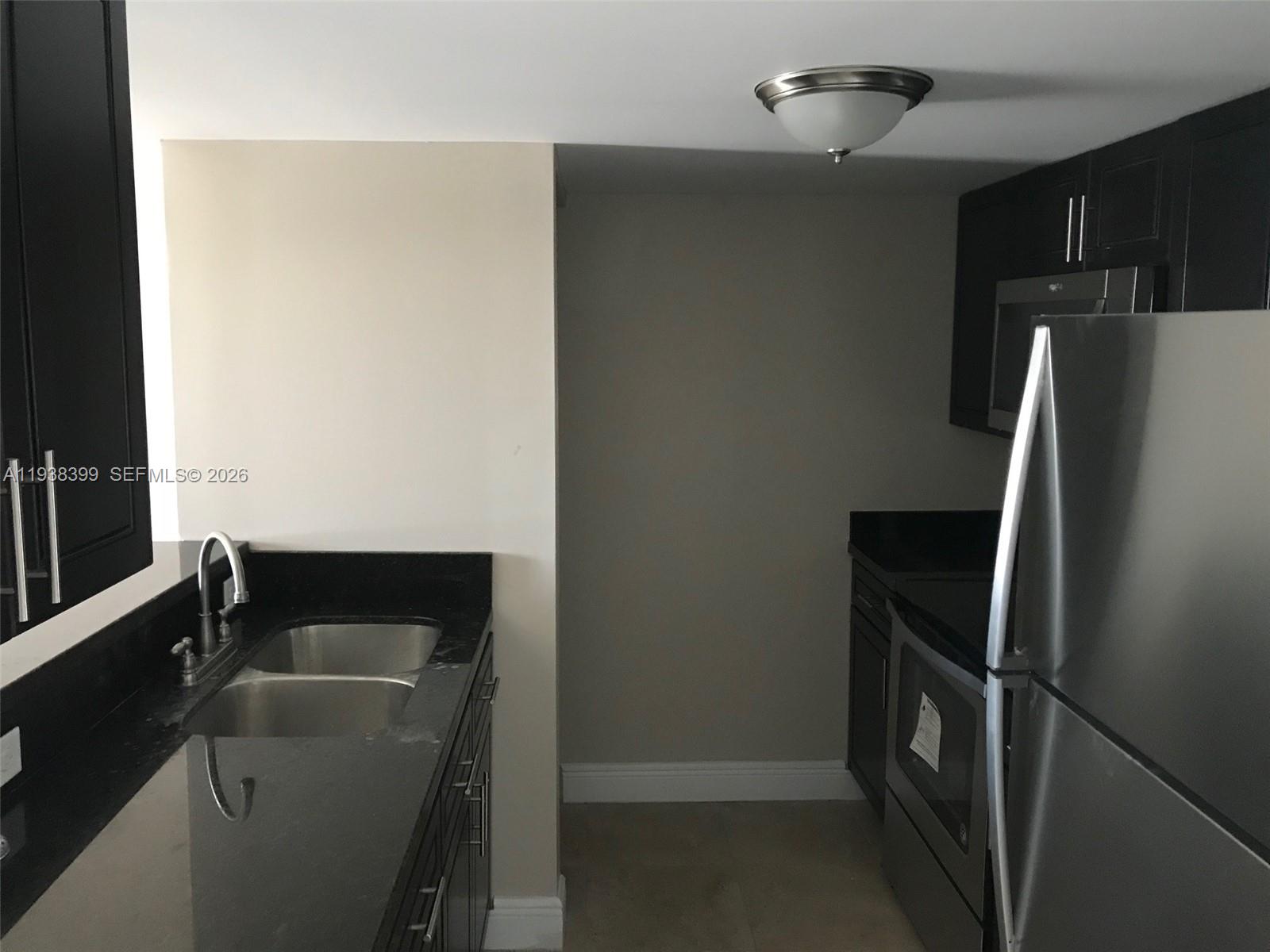 a kitchen with a refrigerator and a sink