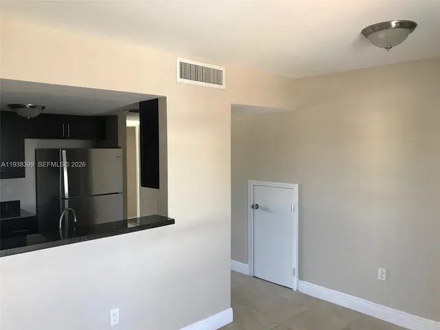 a view of a hallway with wooden floor and closet