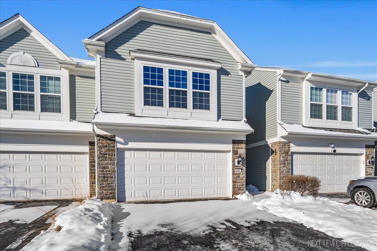643 Hawley Drive, Unit 643 Oswego, IL 60543 - Photo 1 of 27 a front view of a house with a garage
