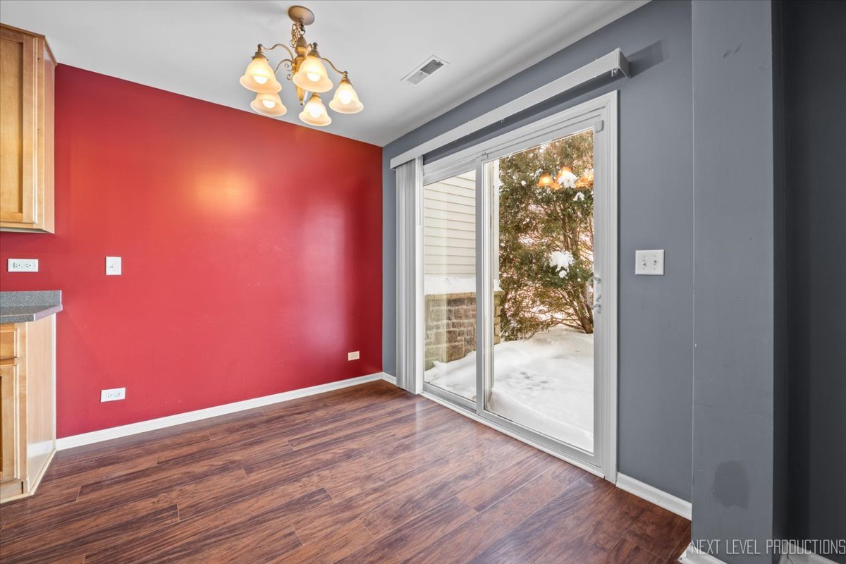 643 Hawley Drive, Unit 643 Oswego, IL 60543 - Photo 13 of 27 a view of a livingroom with wooden floor and a large window