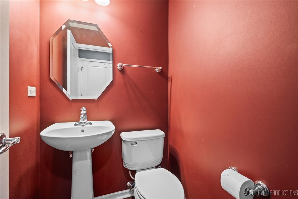 643 Hawley Drive, Unit 643 Oswego, IL 60543 - Photo 14 of 27 a bathroom with a toilet sink and mirror