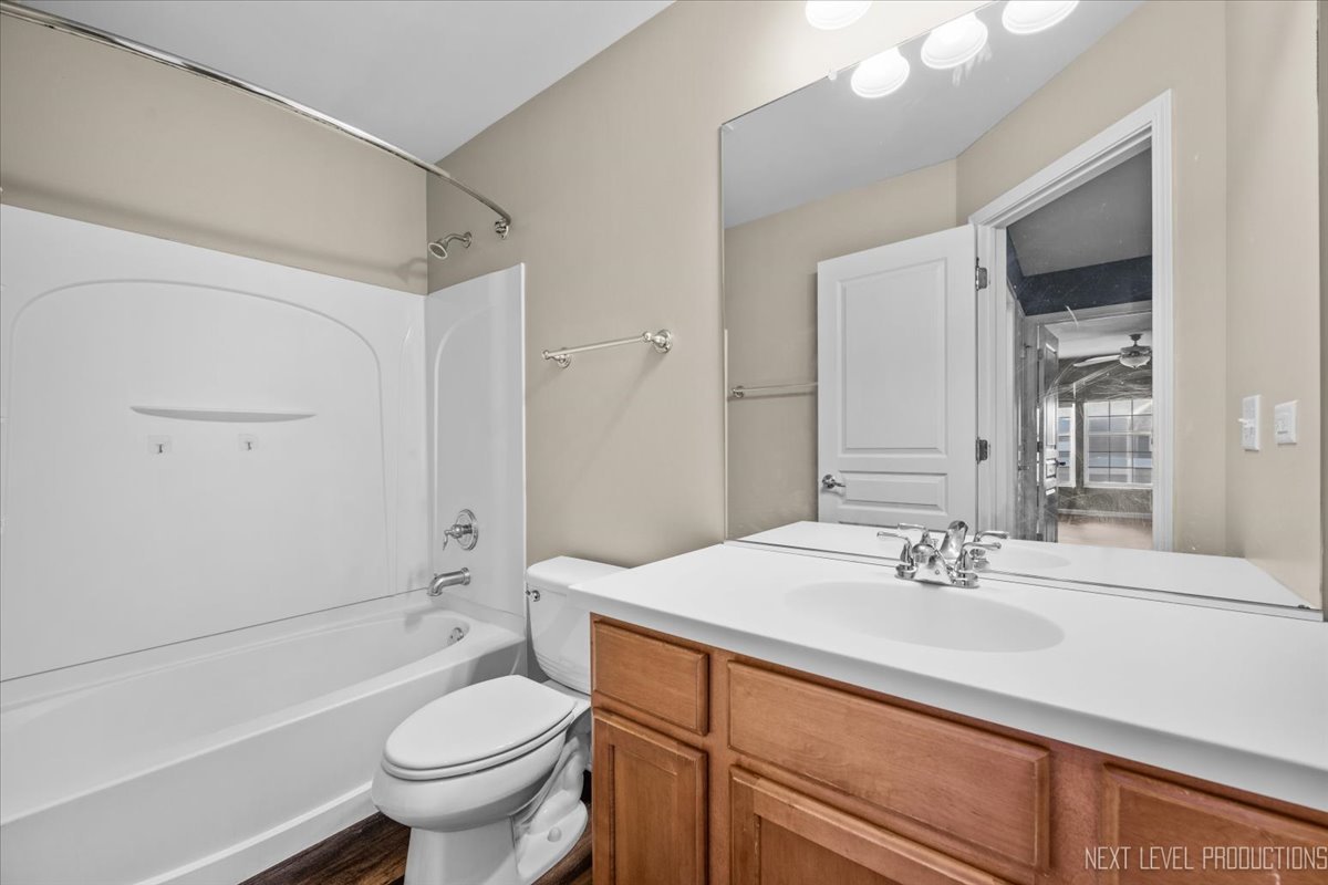 643 Hawley Drive, Unit 643 Oswego, IL 60543 - Photo 17 of 27 a bathroom with a sink toilet vanity and shower