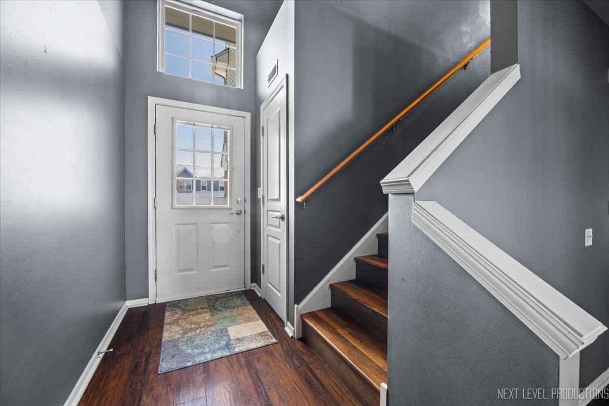 643 Hawley Drive, Unit 643 Oswego, IL 60543 - Photo 3 of 27 a view of entryway with wooden floor and stairs