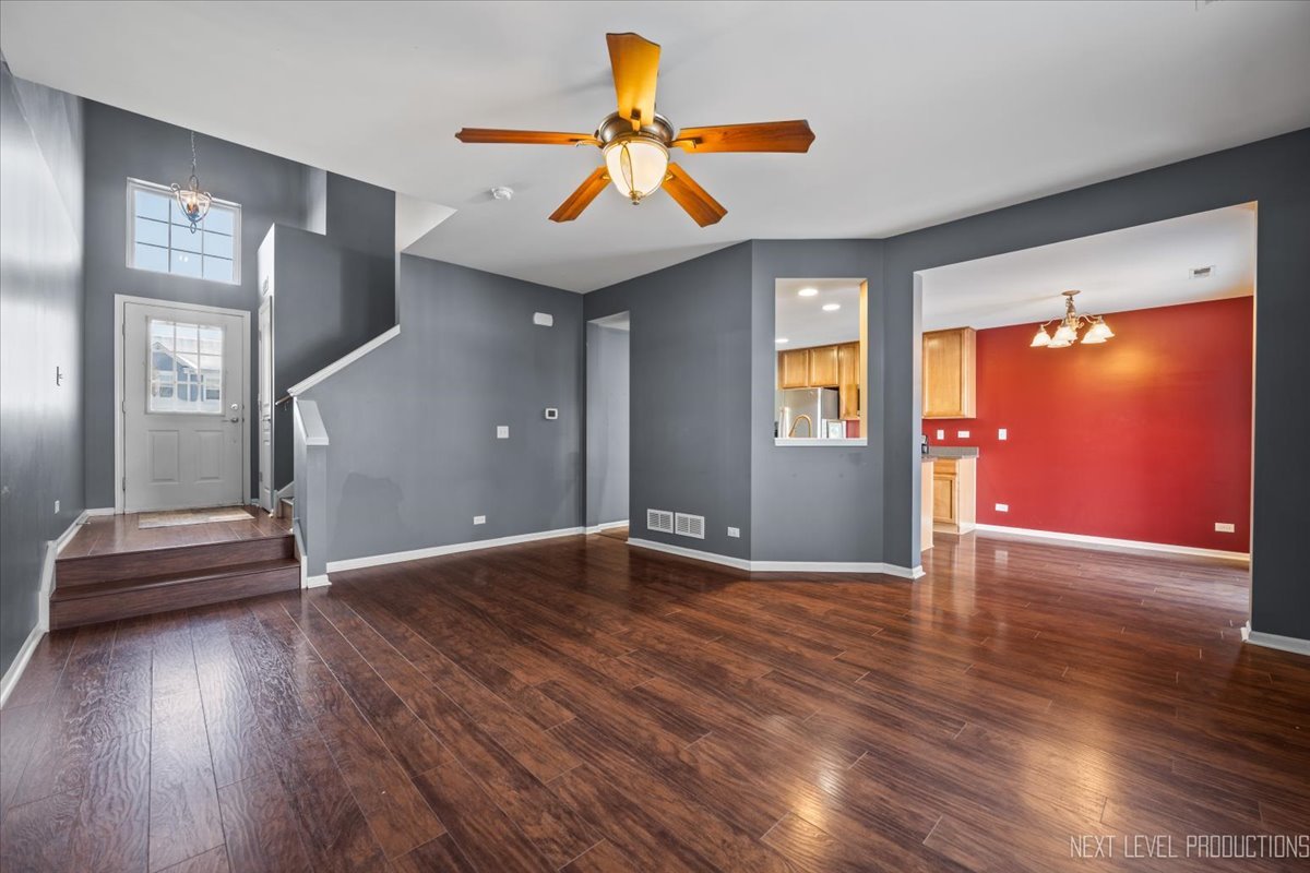 643 Hawley Drive, Unit 643 Oswego, IL 60543 - Photo 5 of 27 a view of an empty room with window and wooden floor