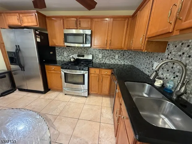 a kitchen with a sink a stove and a microwave