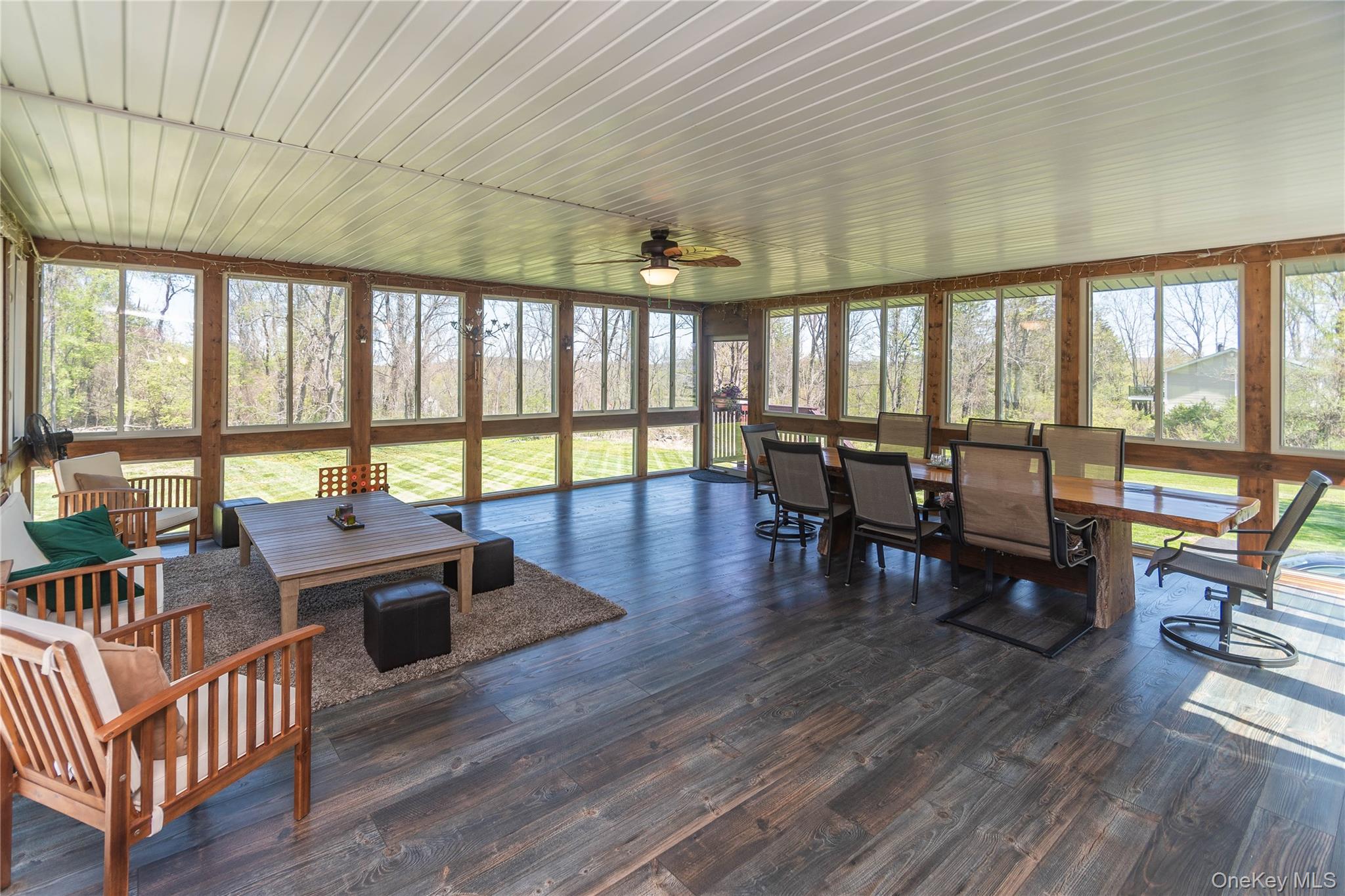 3 Duby Road Wallkill, NY 12589 - Photo 12 of 40 Expansive screened porch featuring wood-finish flooring, a white paneled ceiling, and numerous windows