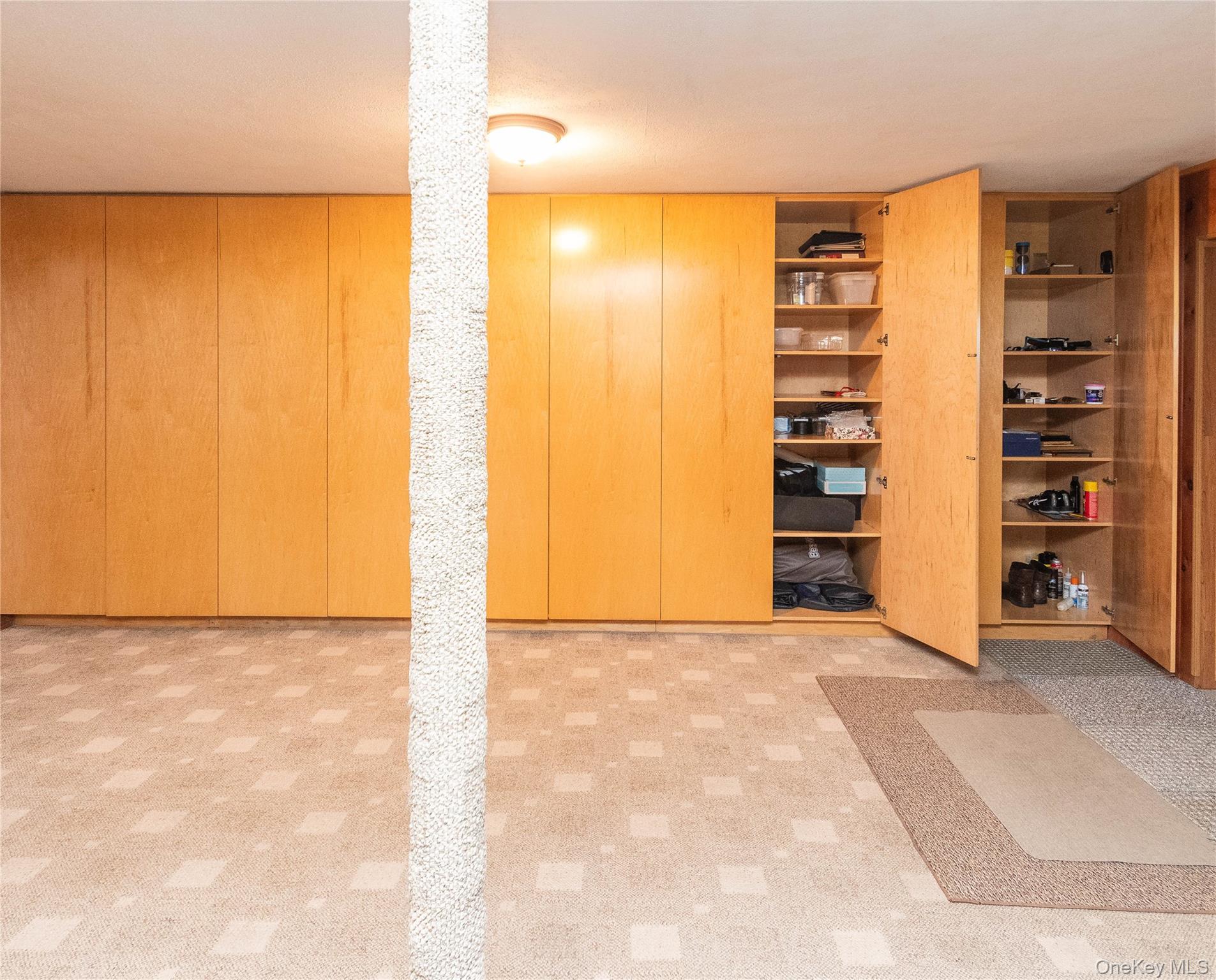 3 Duby Road Wallkill, NY 12589 - Photo 36 of 40 Integrated wood-finish cabinetry spanning the wall with a built-in shelving system