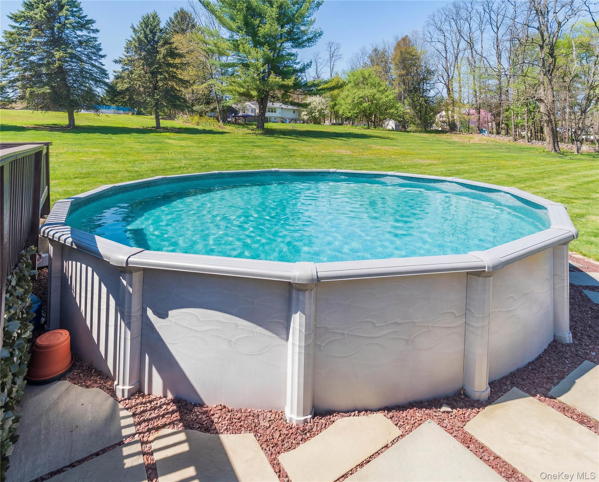 3 Duby Road Wallkill, NY 12589 - Photo 6 of 40 Above-ground pool featuring a stone paver and red gravel surround