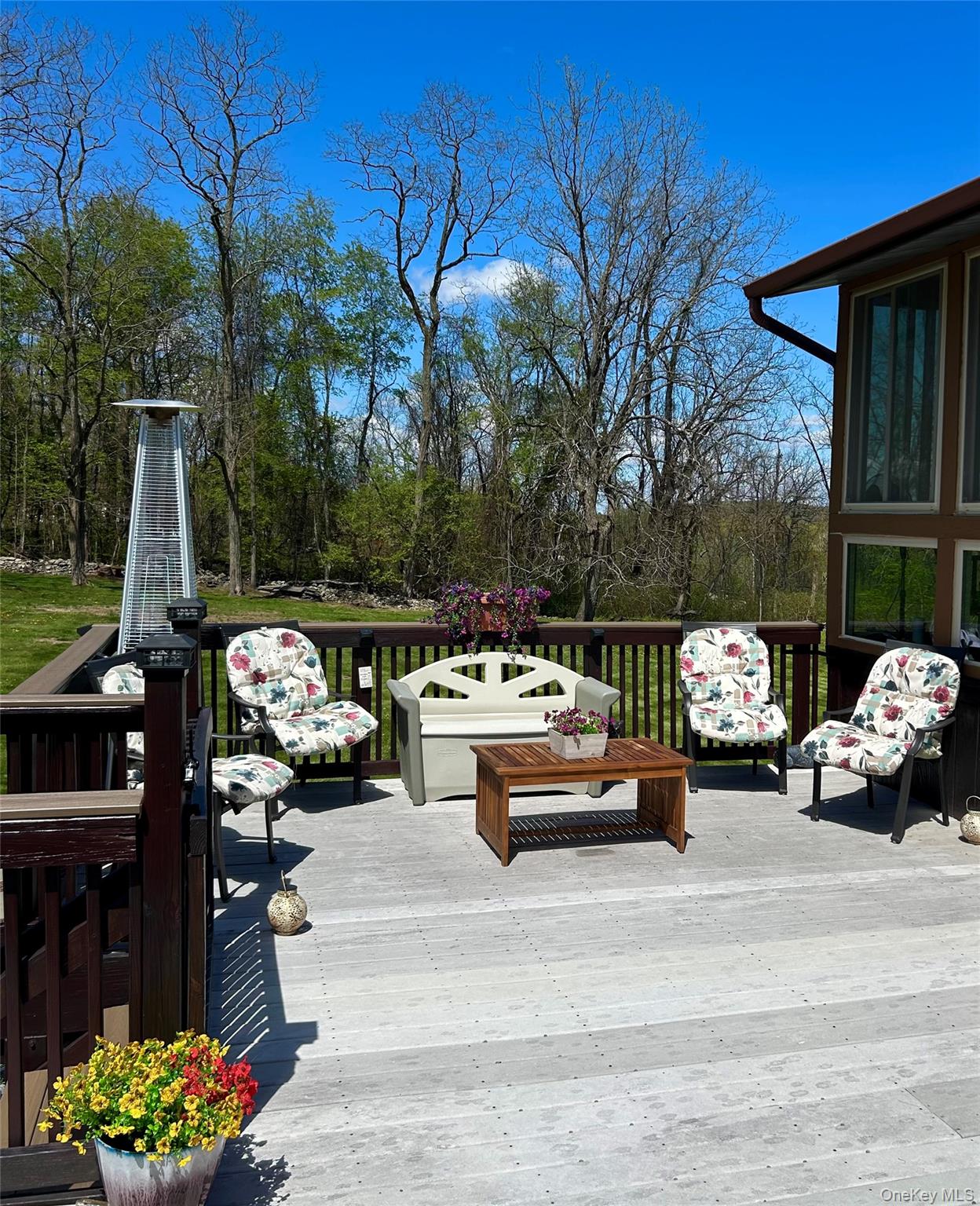 3 Duby Road Wallkill, NY 12589 - Photo 9 of 40 Spacious outdoor deck with composite decking, dark wood railing, and a clear view of mature trees
