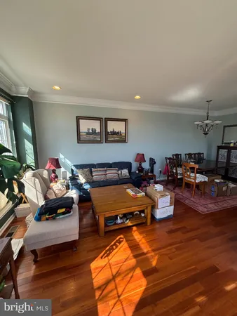 a living room with furniture kitchen view and a flat screen tv