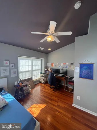 a living room with furniture kitchen view and a large window