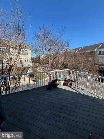 a view of a roof deck with wooden fence and floor