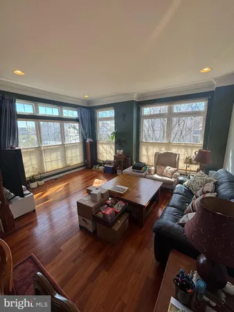 a living room with furniture a rug and a large window