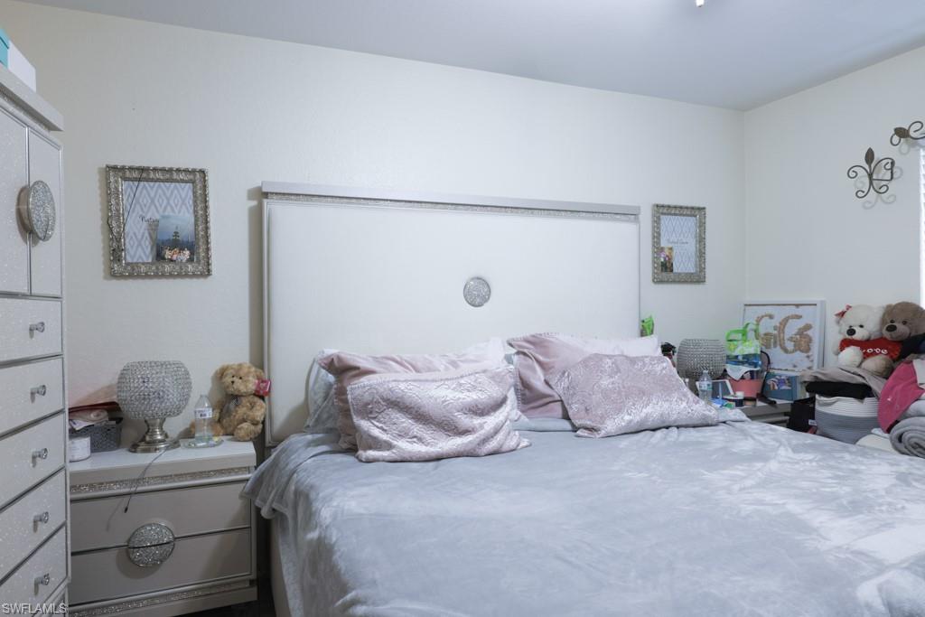 2300 Hunter Boulevard Naples, FL 34116 - Photo 12 of 16 a bedroom with a bed and furniture