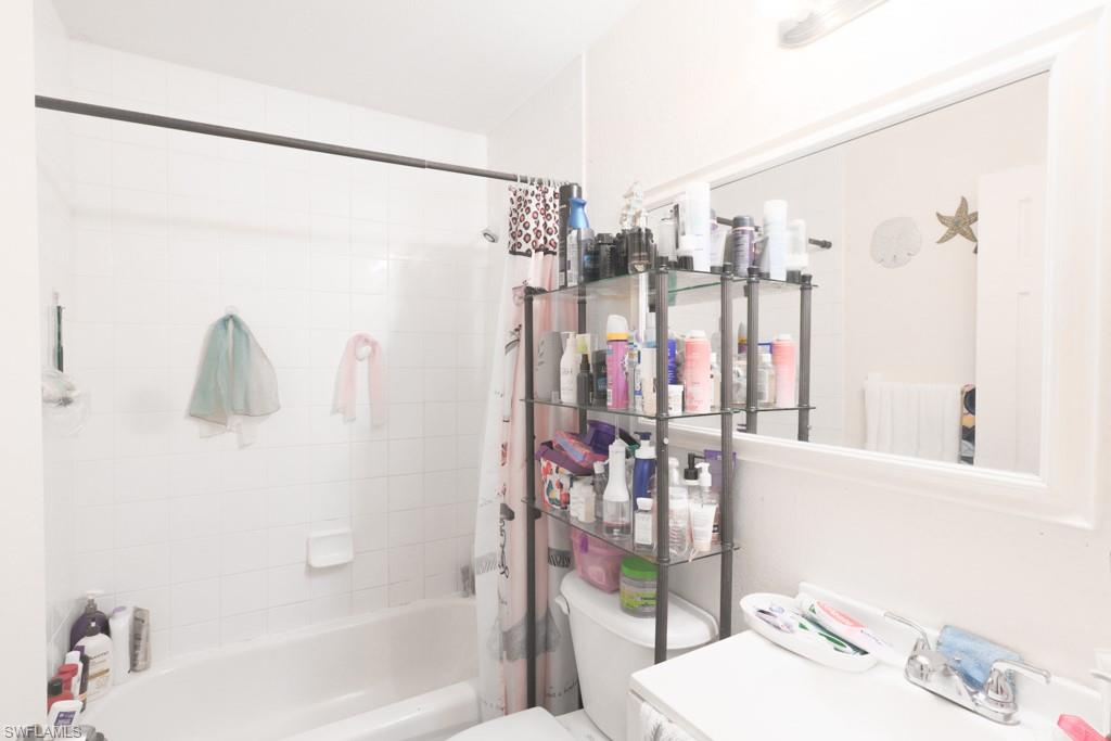 2300 Hunter Boulevard Naples, FL 34116 - Photo 14 of 16 a bathroom with a shower curtain and a sink