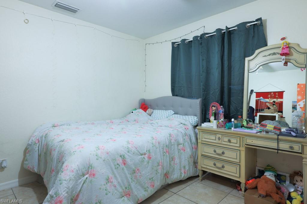 2300 Hunter Boulevard Naples, FL 34116 - Photo 4 of 16 a bedroom with a bed and a dresser
