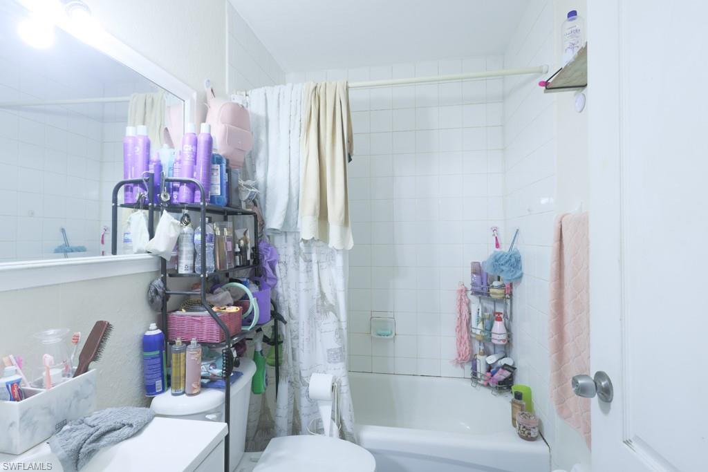 2300 Hunter Boulevard Naples, FL 34116 - Photo 7 of 16 a bathroom with a sink mirror vanity and toilet