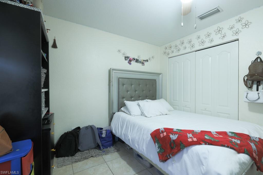 2300 Hunter Boulevard Naples, FL 34116 - Photo 10 of 16 a bedroom with a bed and a window