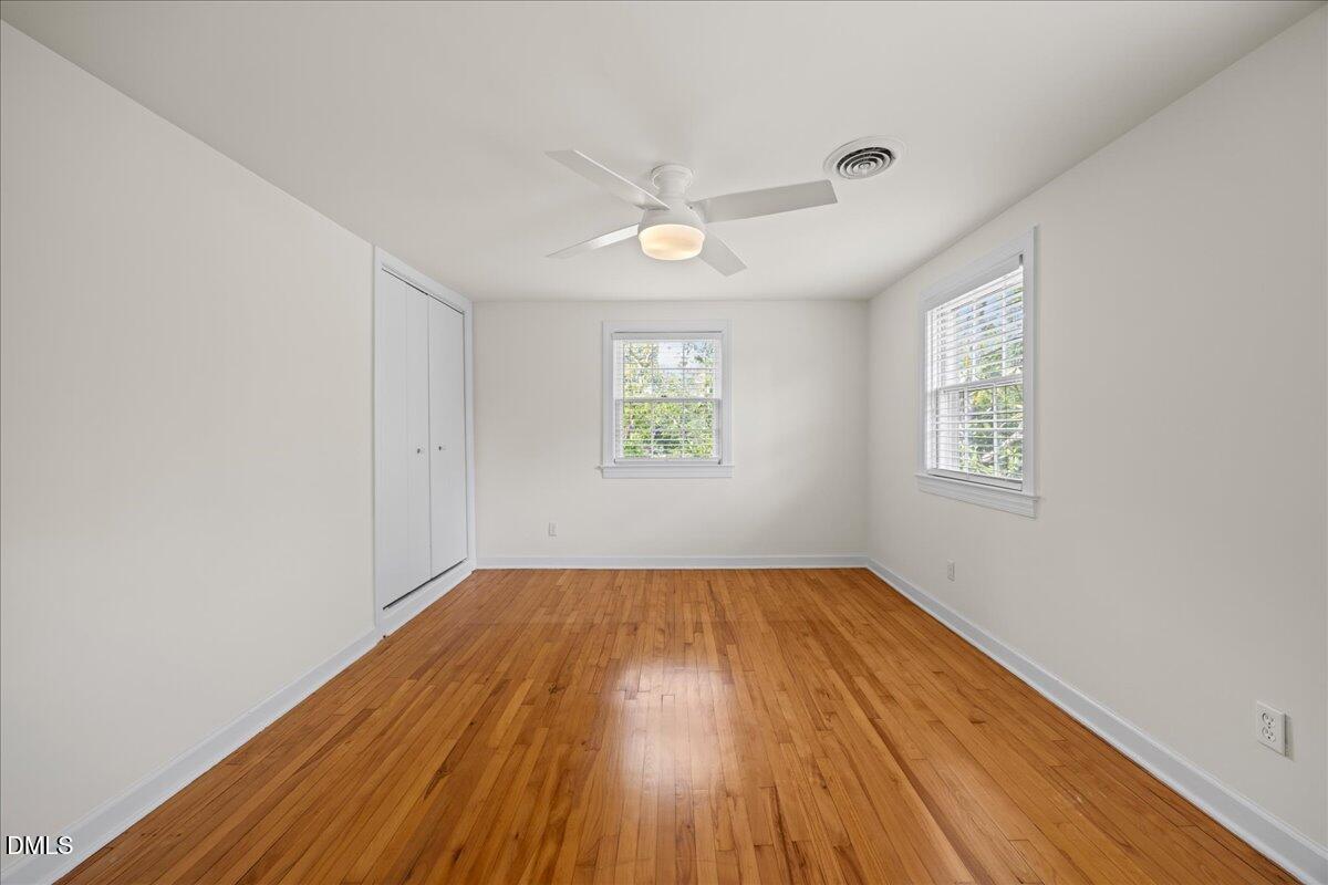 1627 Sutton Drive Raleigh, NC 27605 - Photo 17 of 33 wooden floor in an empty room with a window