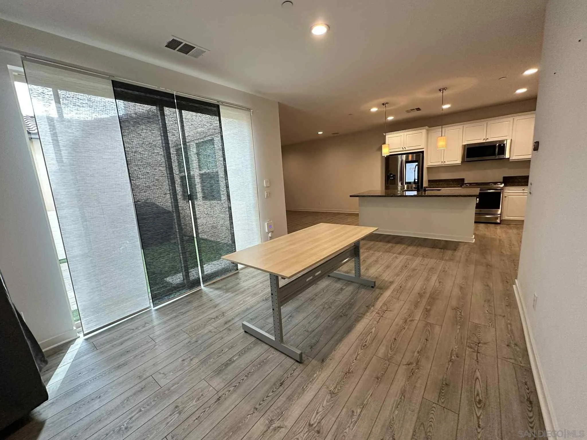 1958 P.º Lugo Chula Vista, CA 91913 - Photo 12 of 68 a open kitchen with stainless steel appliances a refrigerator a sink dishwasher and a wooden floor