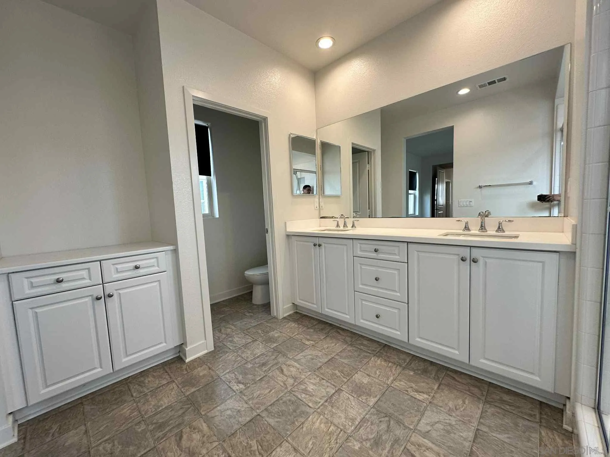 1958 P.º Lugo Chula Vista, CA 91913 - Photo 57 of 68 a spacious bathroom with a double vanity sink a mirror and a