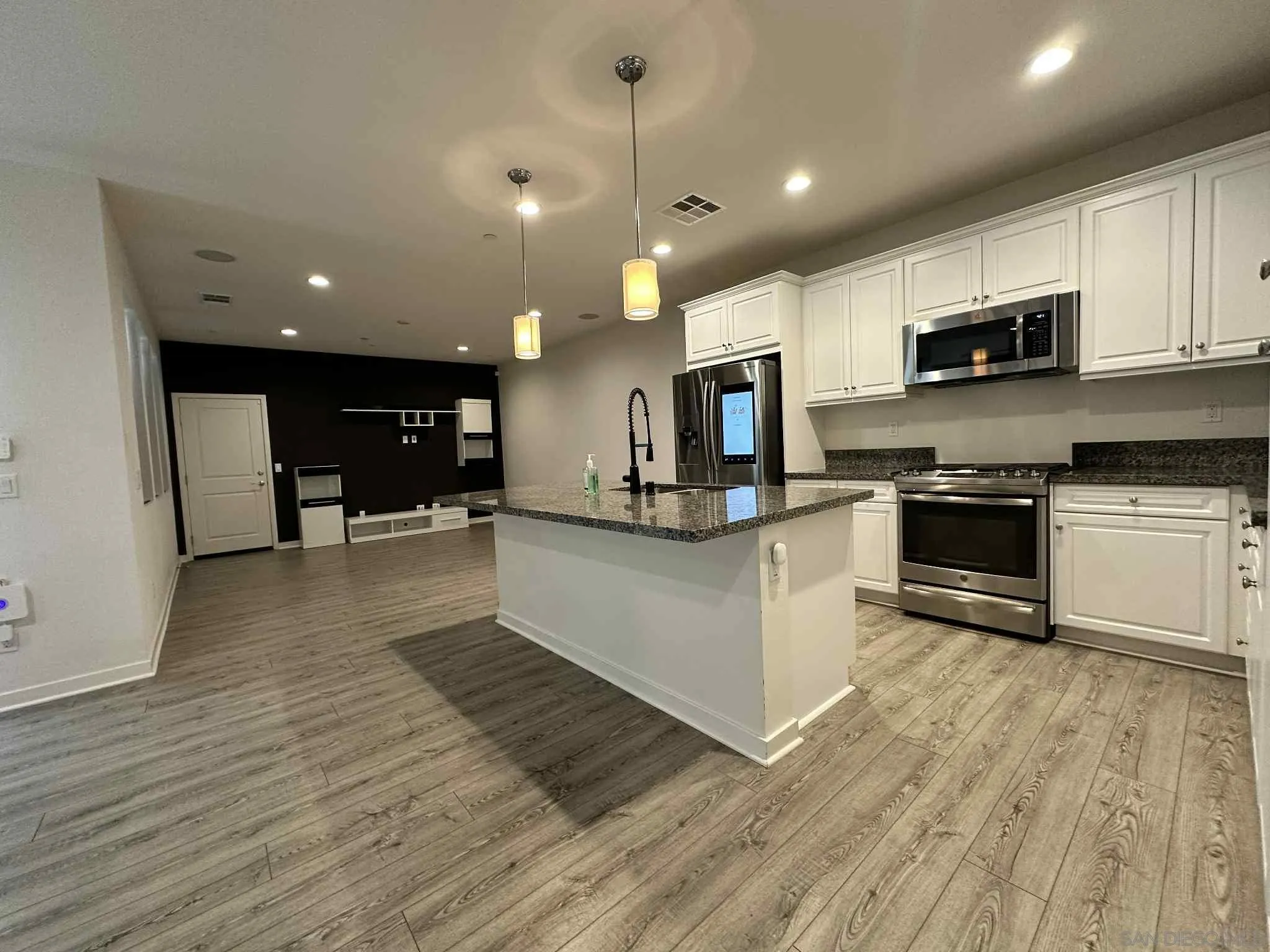 1958 P.º Lugo Chula Vista, CA 91913 - Photo 9 of 68 a view of kitchen with granite countertop stainless steel appliances and wooden floor