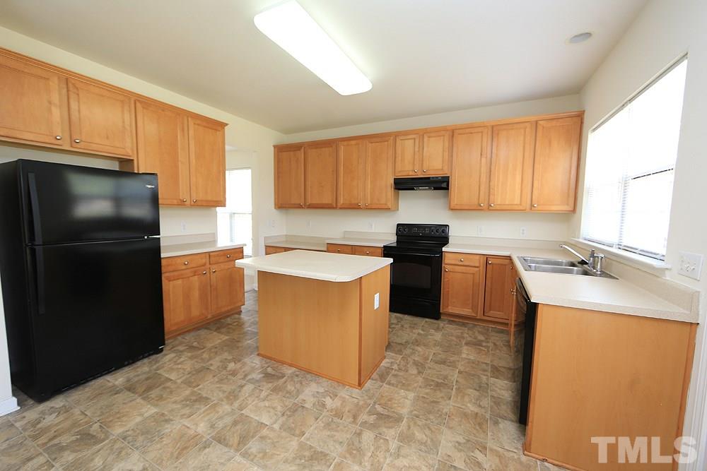 Spacious kitchen with island, stained cabinets, etc.
