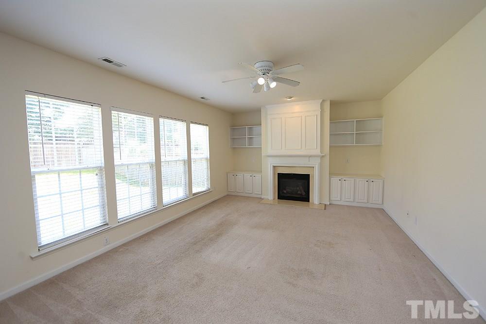 Large room with fireplace and built-ins.