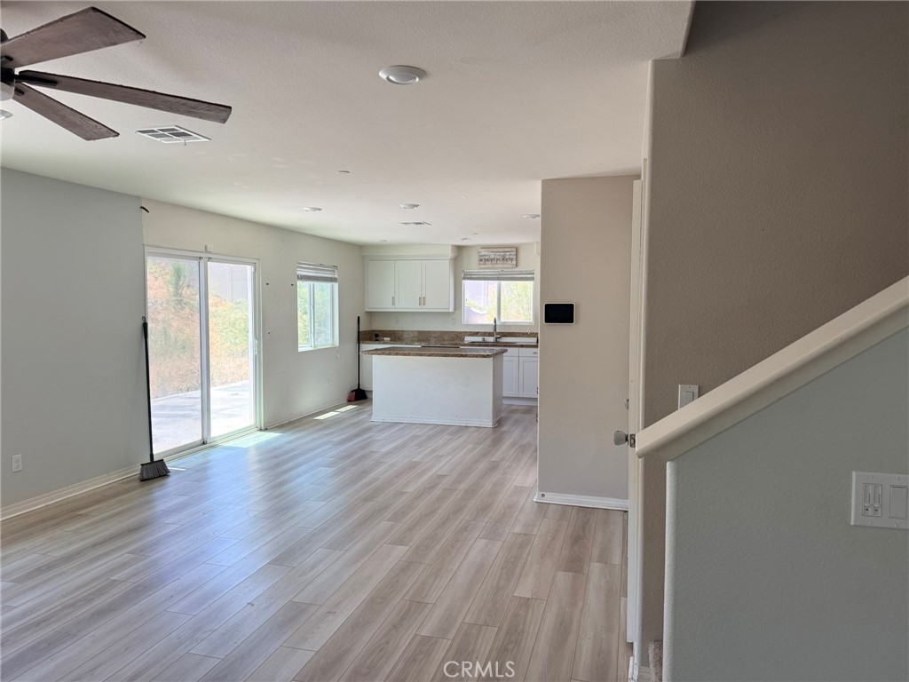 32201 Rambling Court Winchester, CA 92596 - Photo 3 of 11 a view of a kitchen with wooden floor and electronic appliances