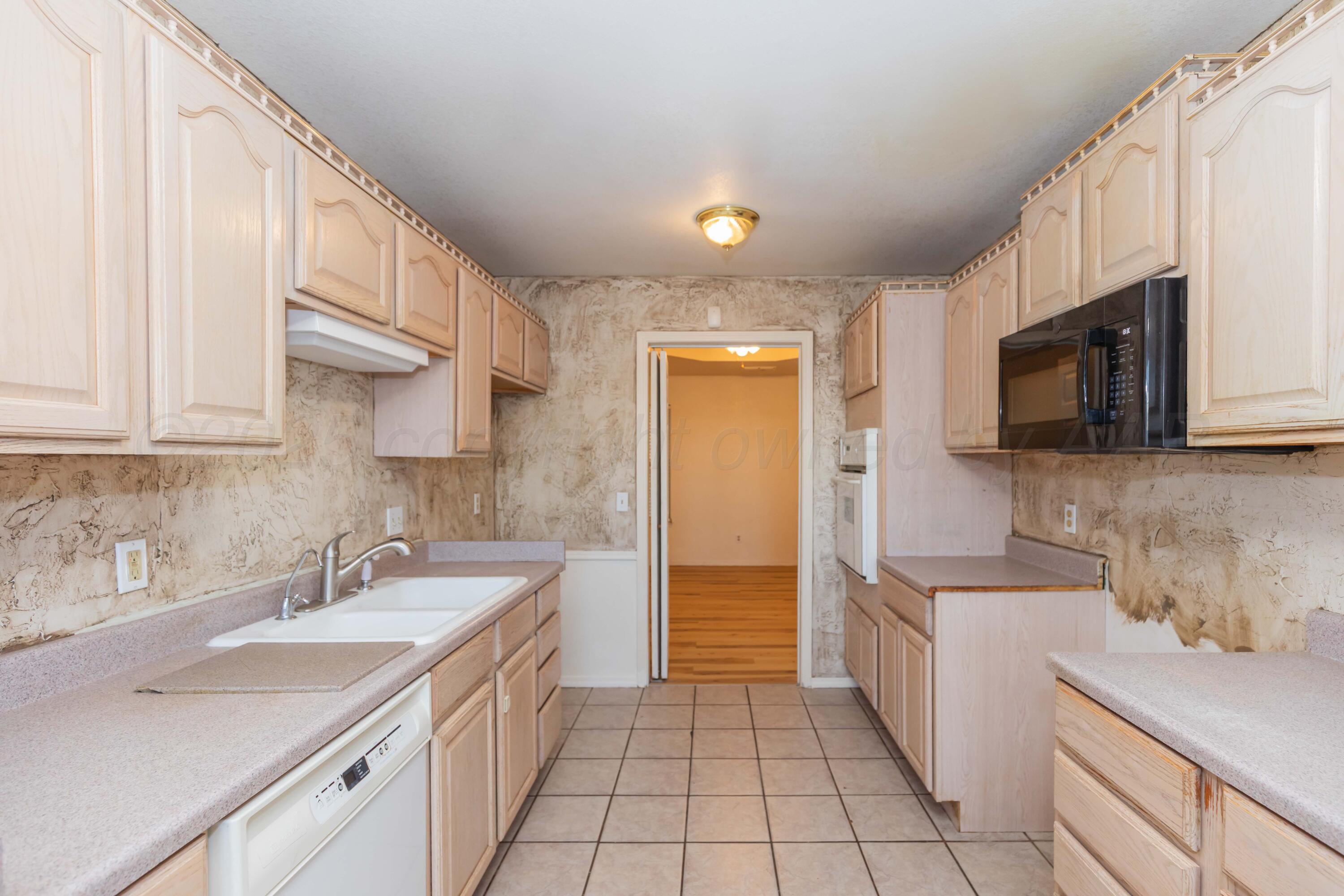 5230 Royce Drive Amarillo, TX 79110 - Photo 11 of 57 a kitchen with a sink a stove and cabinets