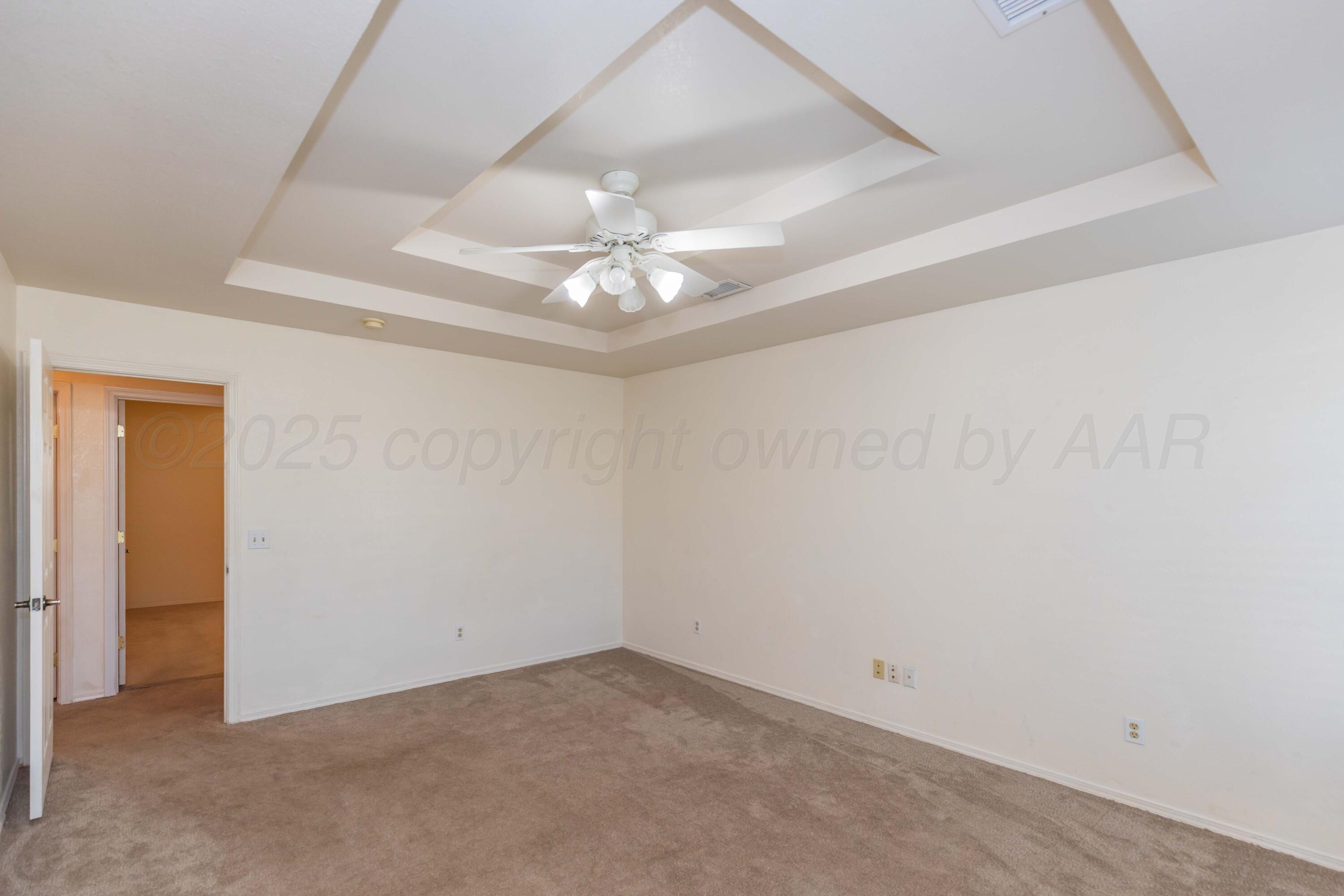 5230 Royce Drive Amarillo, TX 79110 - Photo 27 of 57 an empty room with a ceiling fan and a window