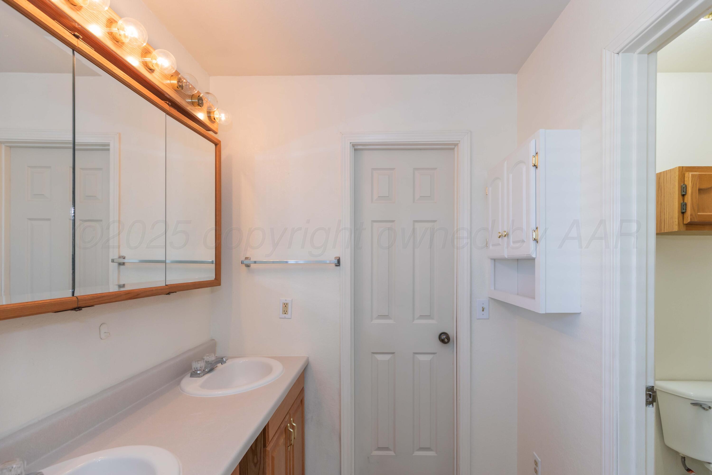5230 Royce Drive Amarillo, TX 79110 - Photo 33 of 57 a bathroom with a sink and mirror