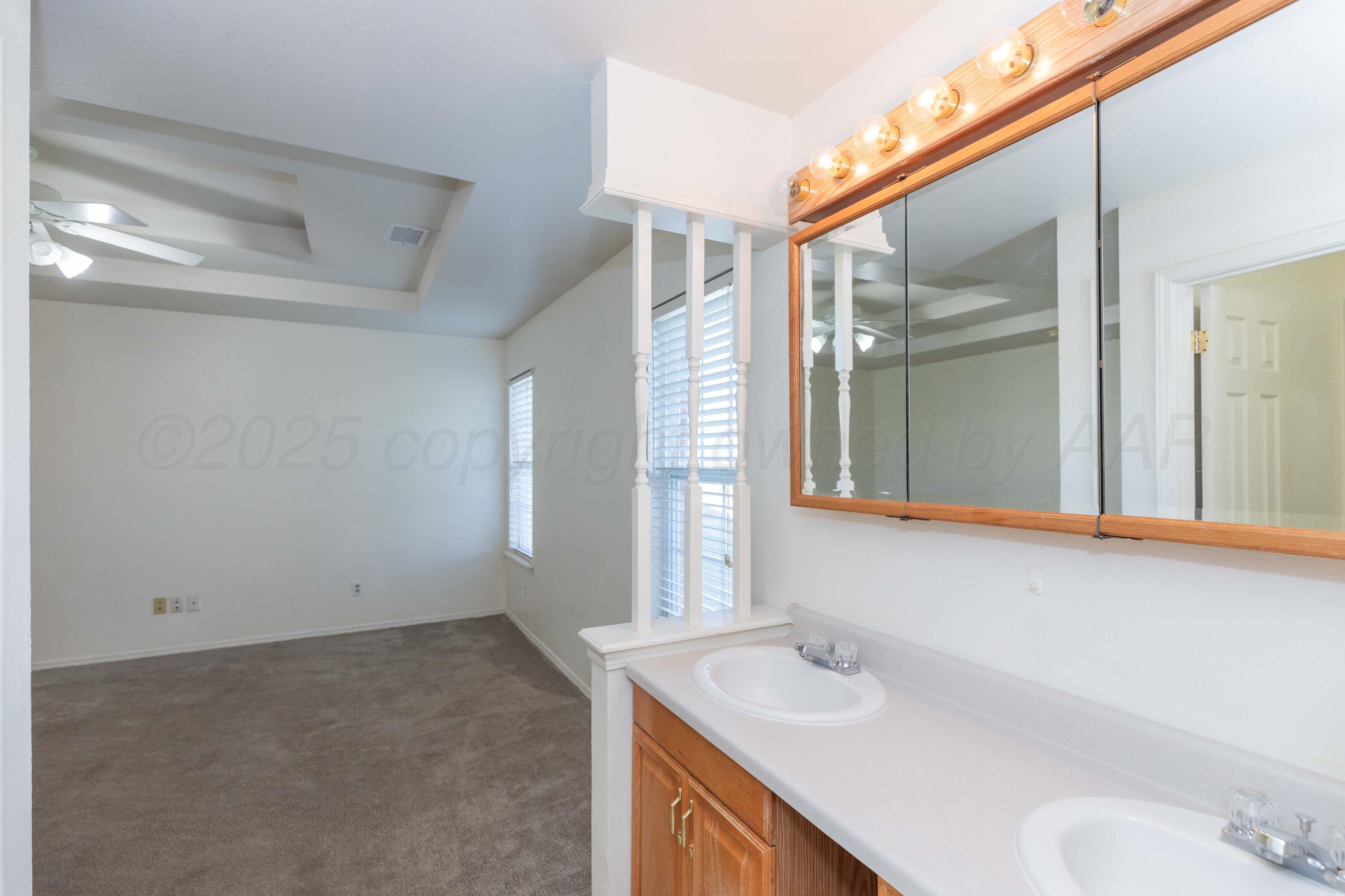 5230 Royce Drive Amarillo, TX 79110 - Photo 35 of 57 a bathroom with a sink and a mirror