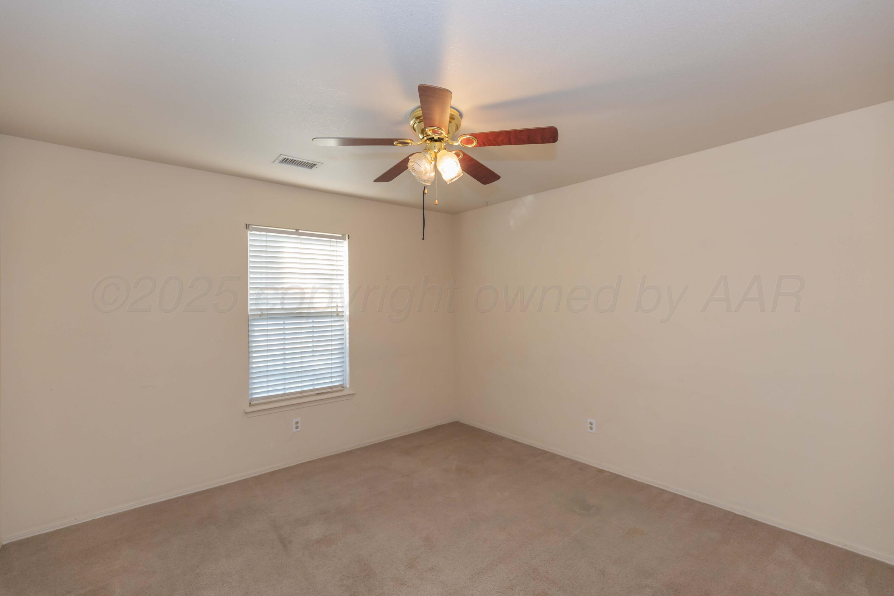 5230 Royce Drive Amarillo, TX 79110 - Photo 36 of 57 an empty room with windows and fan