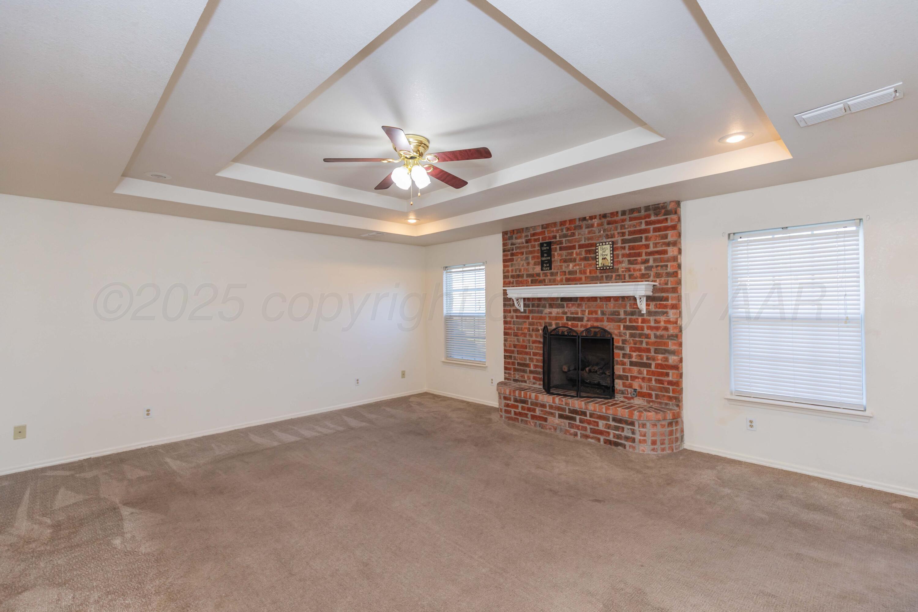 5230 Royce Drive Amarillo, TX 79110 - Photo 8 of 57 an empty room with fireplace and windows