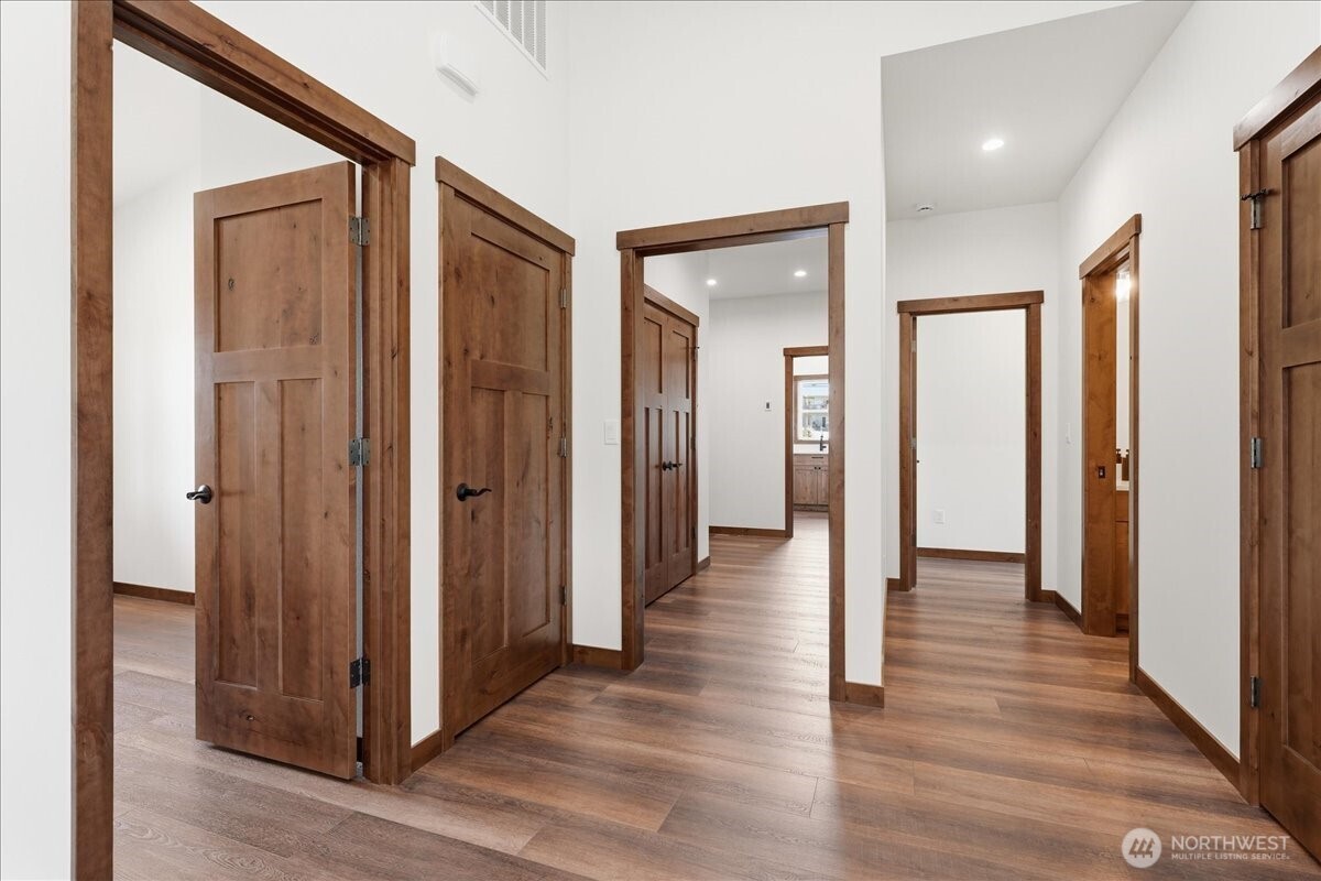110 Slide View Lane Manson, WA 98831 - Photo 16 of 38 a view of a hallway with wooden floor