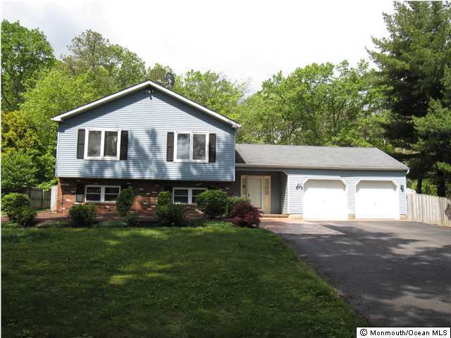 334 Diamond Road Jackson, NJ 08527 - Photo 1 of 3 a front view of a house with a garden and trees