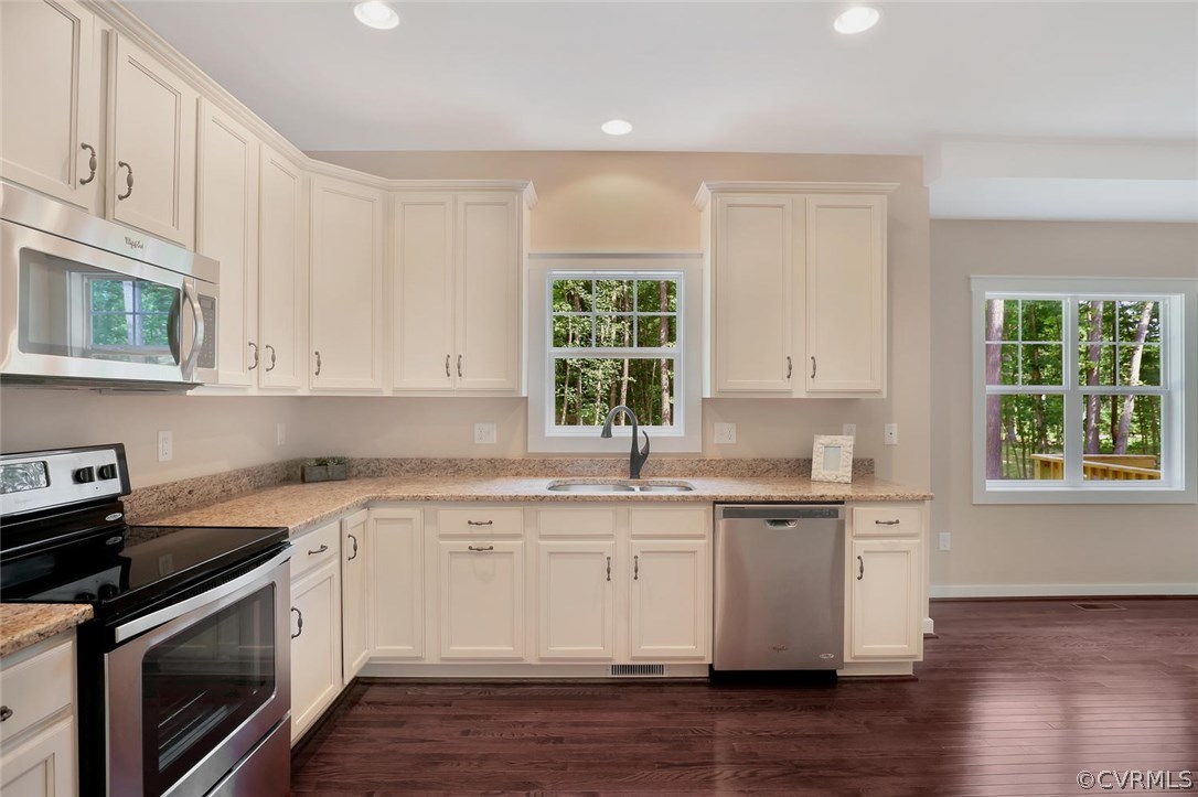 19410 River Road Chesterfield, VA 23838 - Photo 17 of 32 a kitchen with stainless steel appliances granite countertop a sink a stove a microwave and cabinets